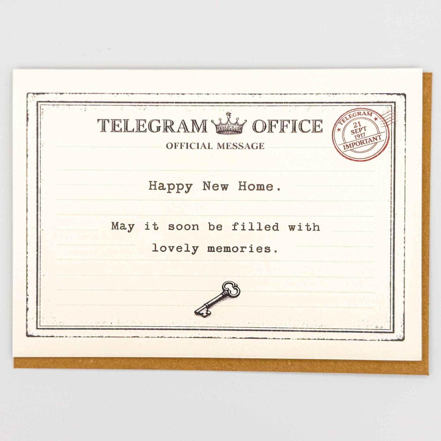 Happy new home telegram card from Sprinkled with Magic, featuring vintage telegram-style wording, small key detail and recycled kraft envelope.