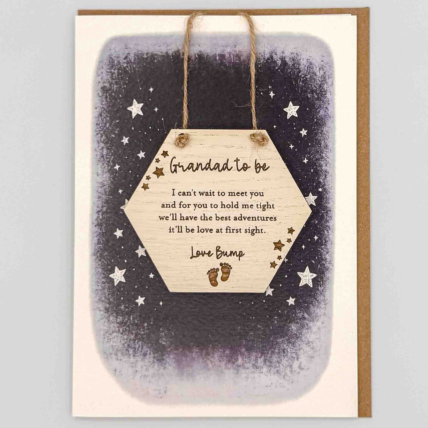 Grandad to be love bump hexagon keepsake card from Sprinkled with Magic, featuring a removable wooden hexagon keepsake, baby feet detail, starry navy design and recycled kraft envelope.