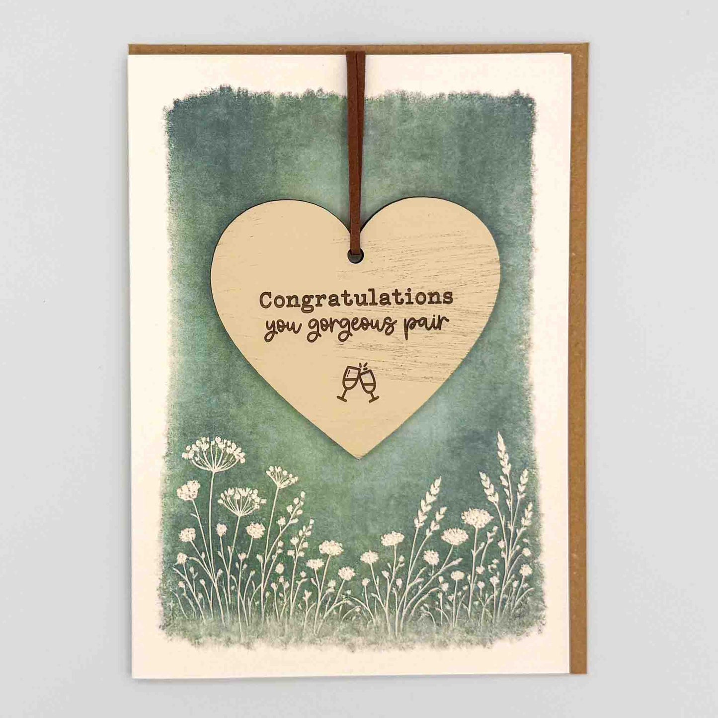 Congratulations gorgeous pair glasses heart keepsake card from Sprinkled with Magic, featuring a removable wooden heart keepsake, glasses detail, green botanical design and recycled kraft envelope.