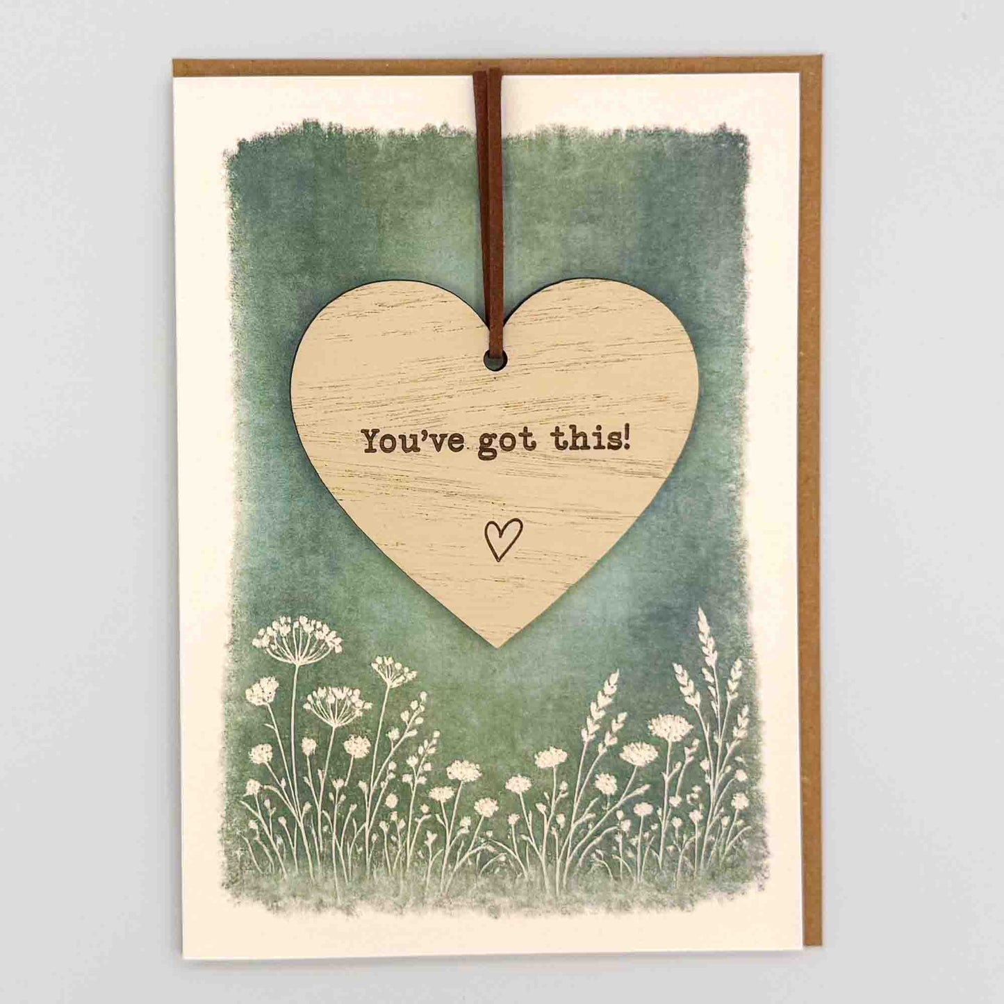 You’ve got this heart keepsake card from Sprinkled with Magic, featuring a removable wooden heart keepsake, green botanical design and recycled kraft envelope.
