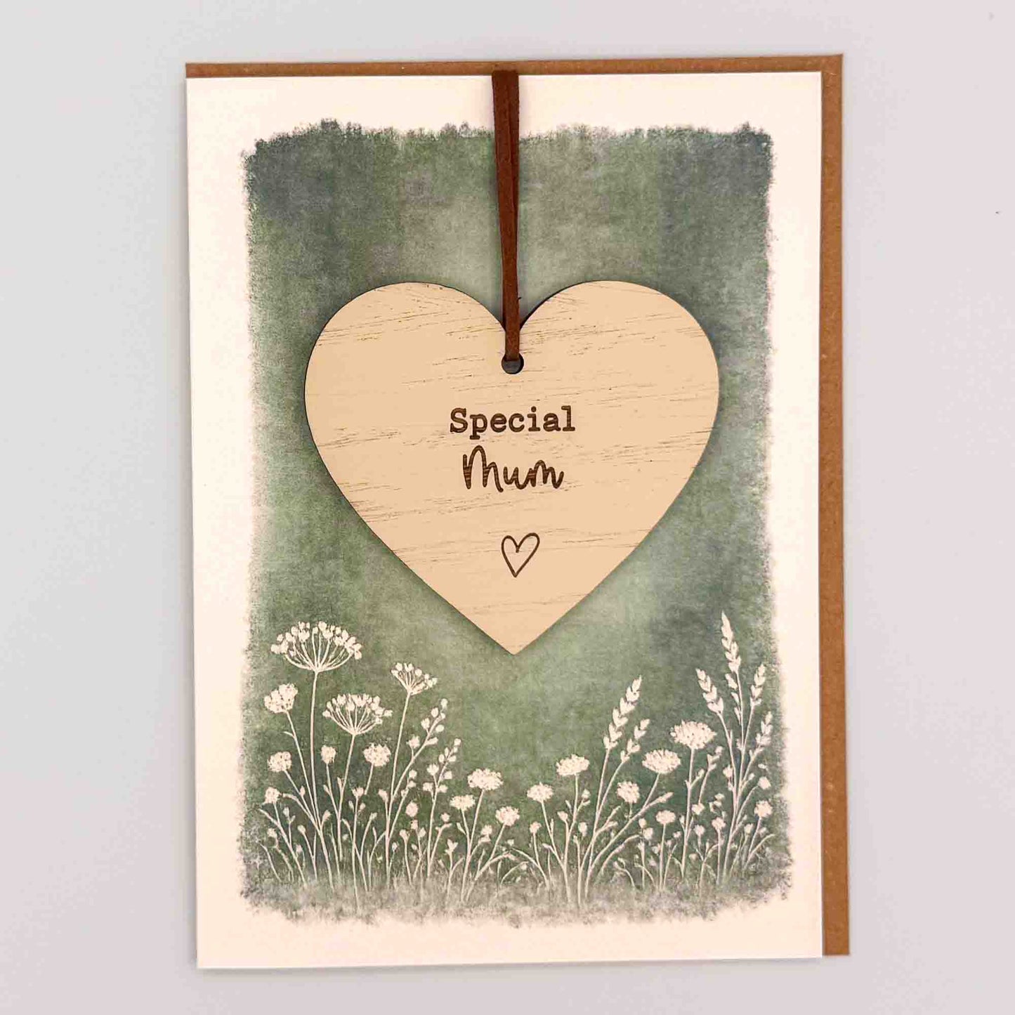 Special Mum heart keepsake card from Sprinkled with Magic, featuring a removable wooden heart keepsake, green botanical design and recycled kraft envelope.