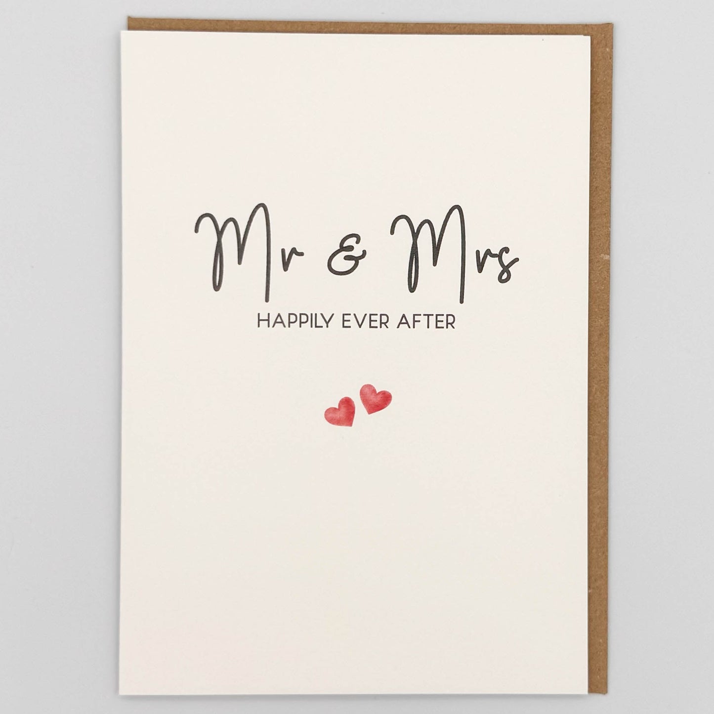 Mr and Mrs wedding card from Sprinkled with Magic, featuring handwritten-style happily ever after wording, two small pink hearts and recycled kraft envelope.
