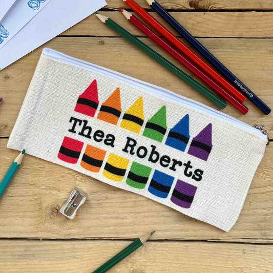 Personalised pencilcase with colourful crayons and a name in the center.  