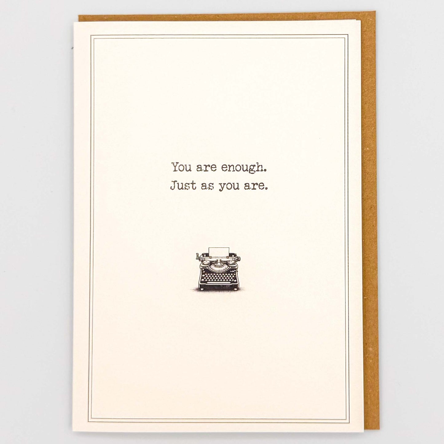 You are enough typewriter card from Sprinkled with Magic, featuring comforting wording, a vintage typewriter illustration and recycled kraft envelope.