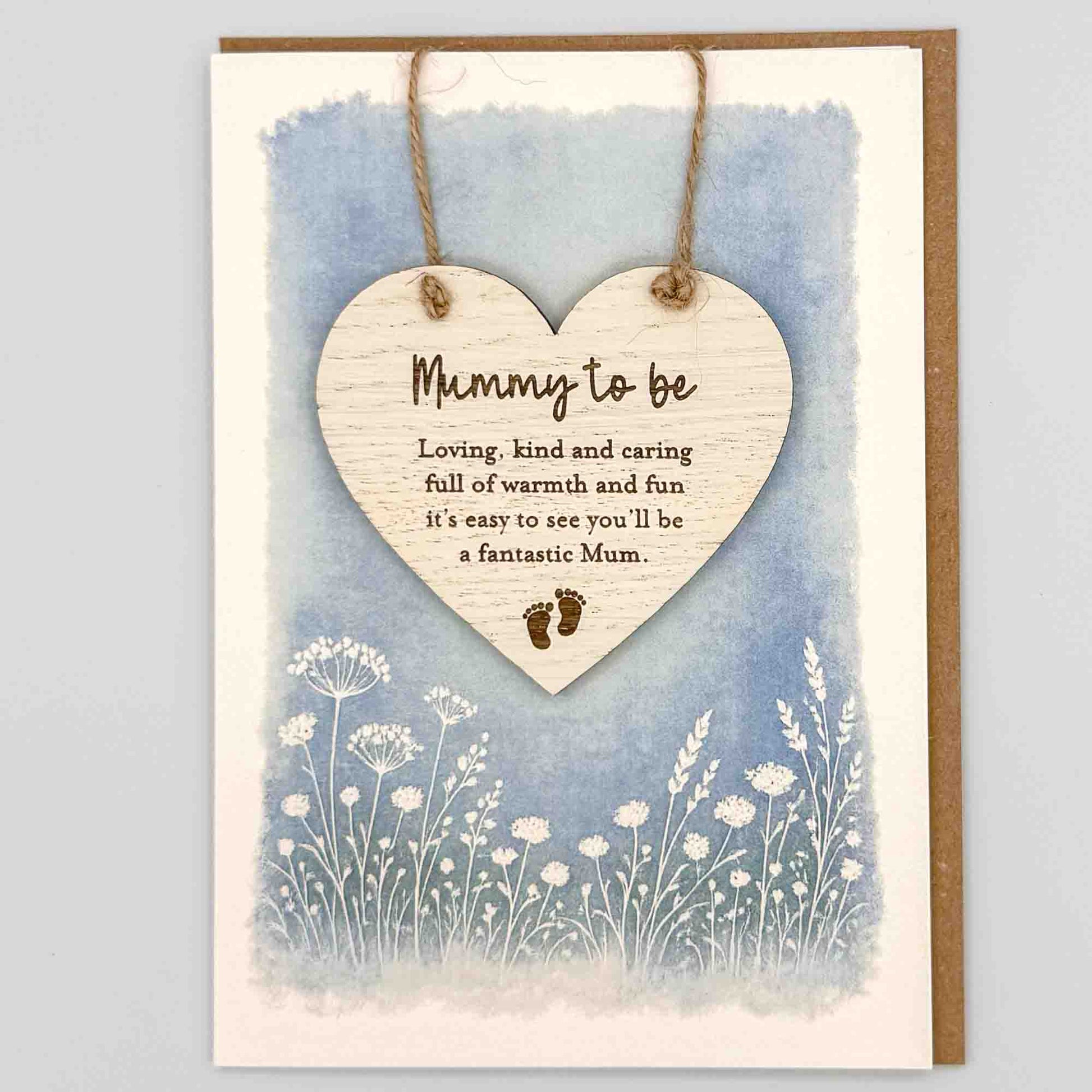 Mummy to be fantastic Mum heart keepsake card from Sprinkled with Magic, featuring a removable wooden heart keepsake, baby feet detail, blue botanical design and recycled kraft envelope.