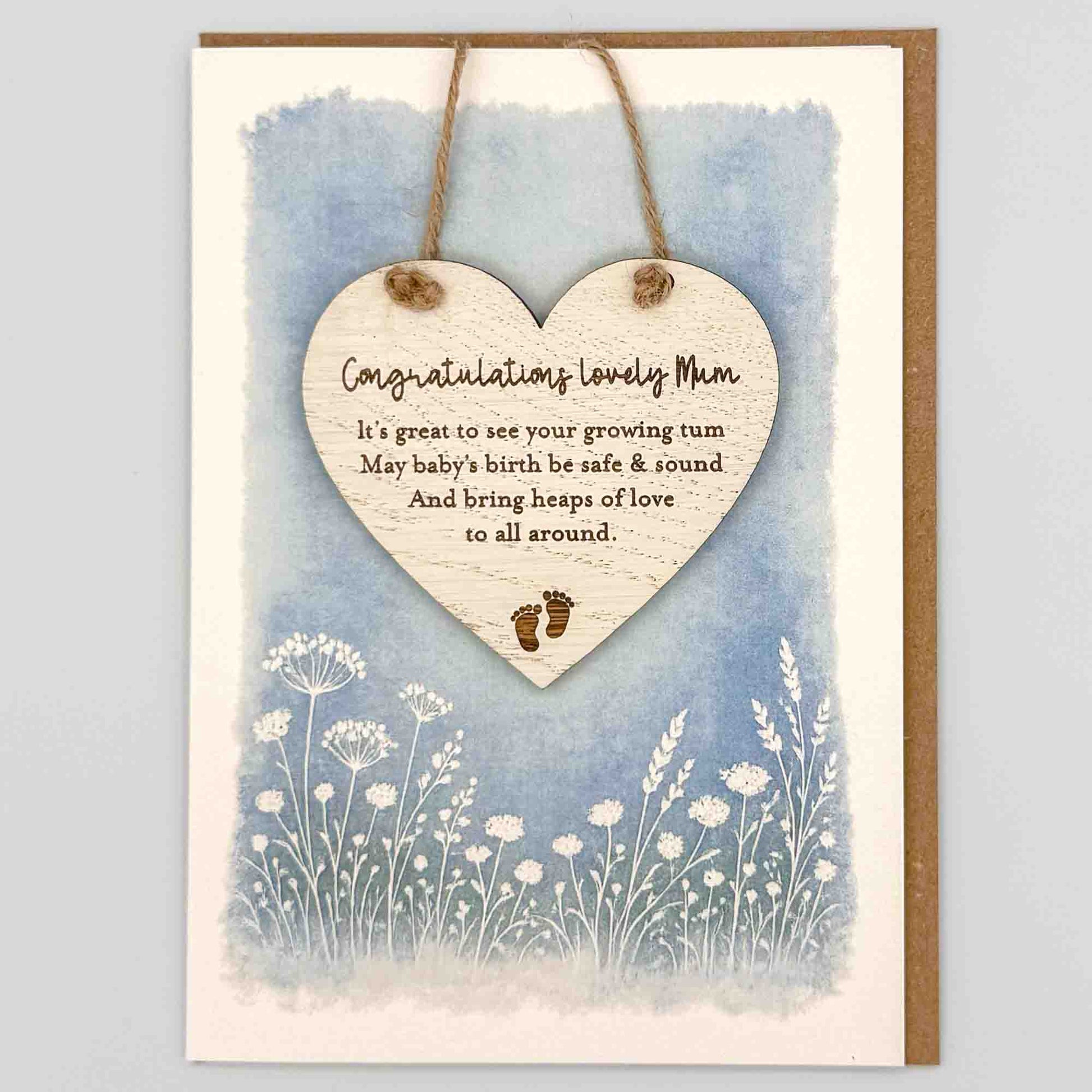 Congratulations lovely mum heart keepsake card from Sprinkled with Magic, featuring a removable wooden heart keepsake, baby feet detail, blue botanical design and recycled kraft envelope.