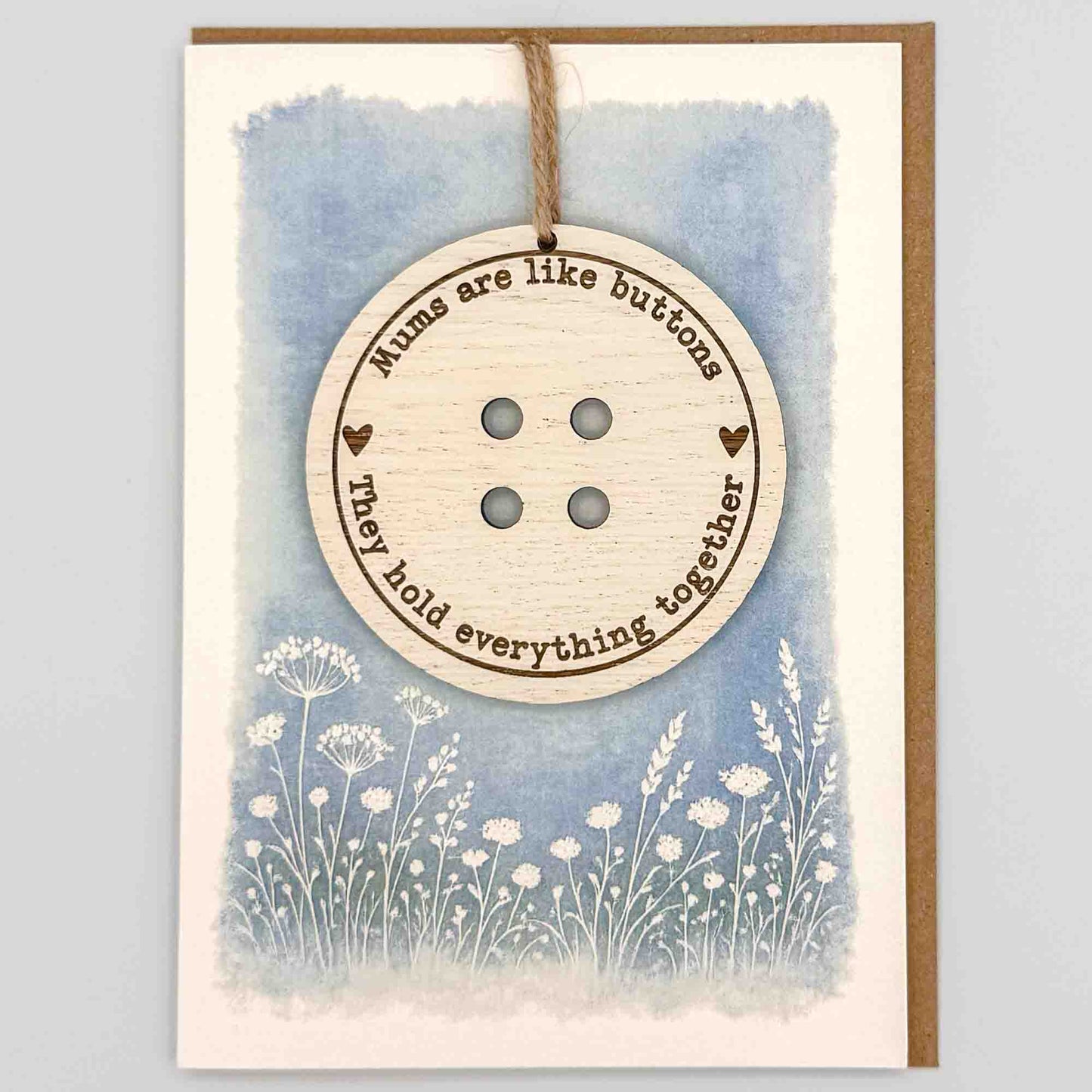 Mums are like buttons keepsake card from Sprinkled with Magic, featuring a removable wooden button keepsake, blue botanical design and recycled kraft envelope.