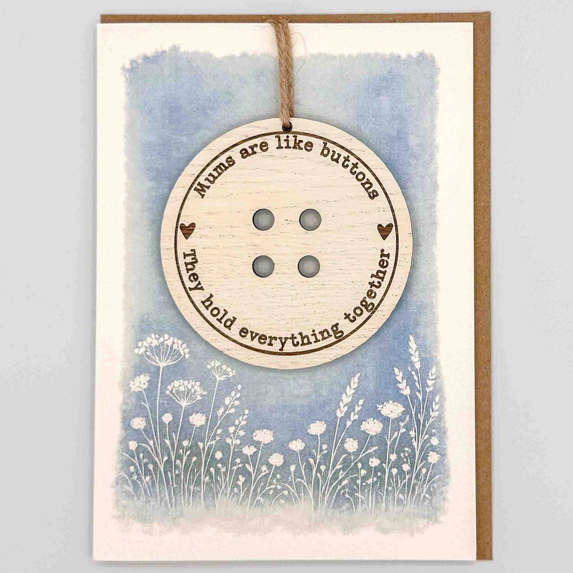 Mums are like buttons keepsake card from Sprinkled with Magic, featuring a removable wooden button keepsake, blue botanical design and recycled kraft envelope.