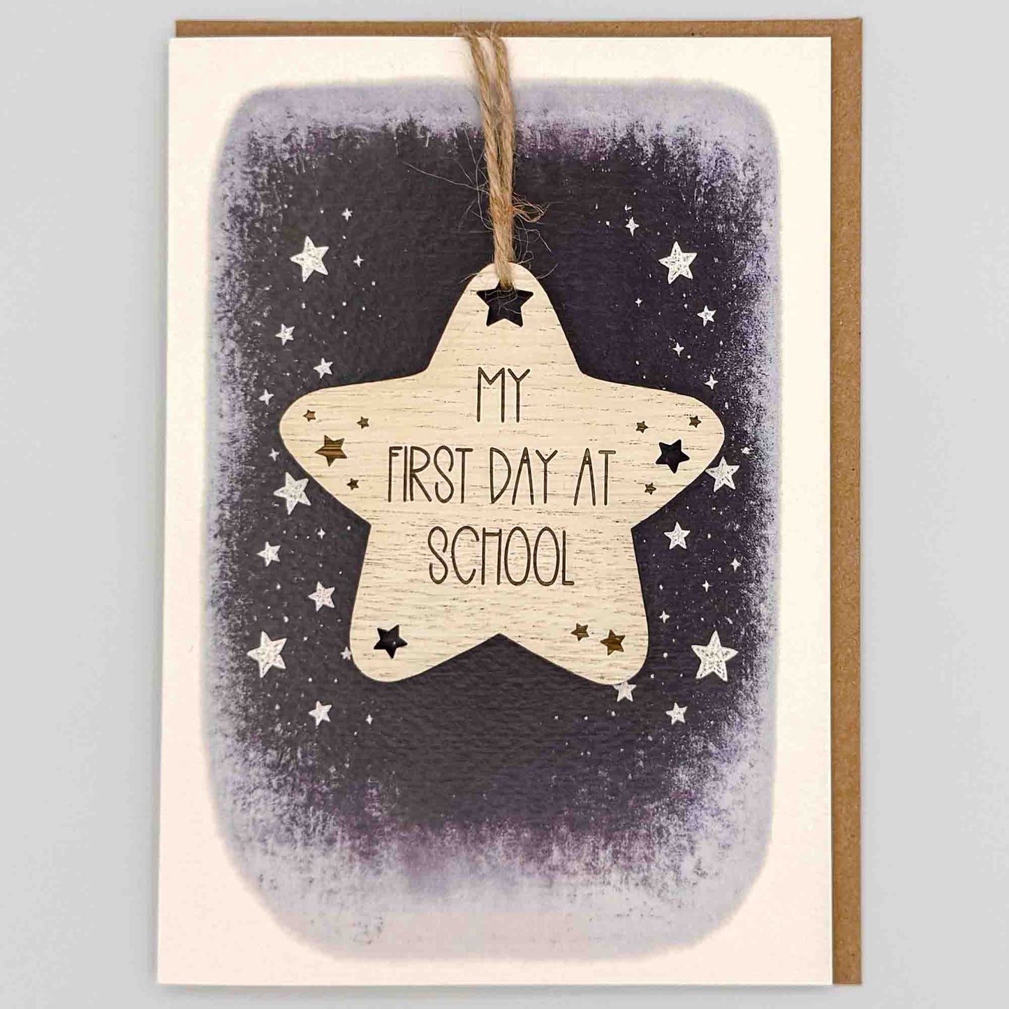 First day at school star keepsake card from Sprinkled with Magic, featuring a removable wooden star keepsake, starry navy design and recycled kraft envelope.