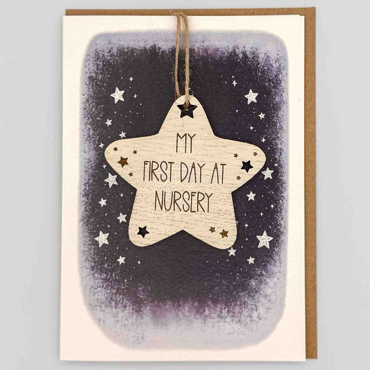 First day at nursery star keepsake card from Sprinkled with Magic, featuring a removable wooden star keepsake, small star details, starry navy design and recycled kraft envelope.