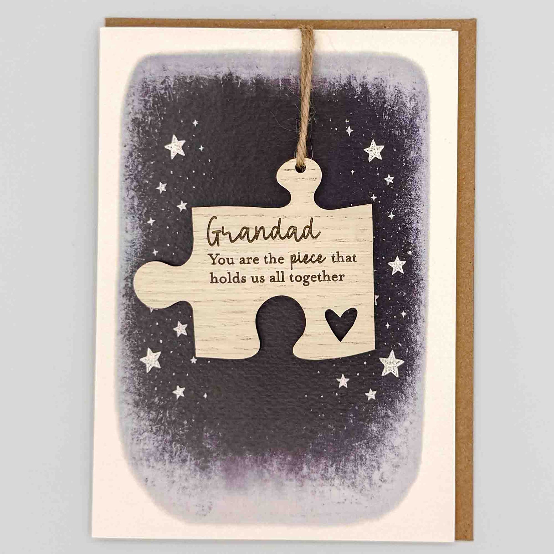 Grandad hold us together jigsaw keepsake card from Sprinkled with Magic, featuring a removable wooden jigsaw keepsake, starry navy design and recycled kraft envelope.
