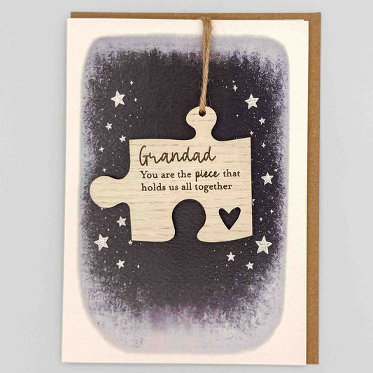 Grandad hold us together jigsaw keepsake card from Sprinkled with Magic, featuring a removable wooden jigsaw keepsake, starry navy design and recycled kraft envelope.