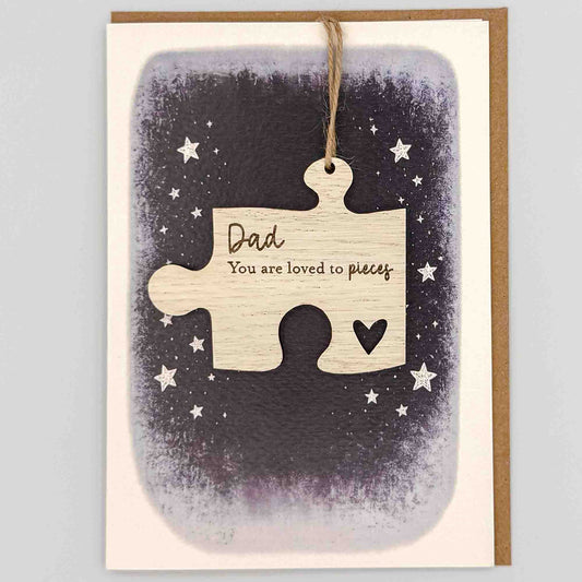 Dad loved to pieces jigsaw keepsake card from Sprinkled with Magic, featuring a removable wooden jigsaw keepsake, small heart detail, starry navy design and recycled kraft envelope.