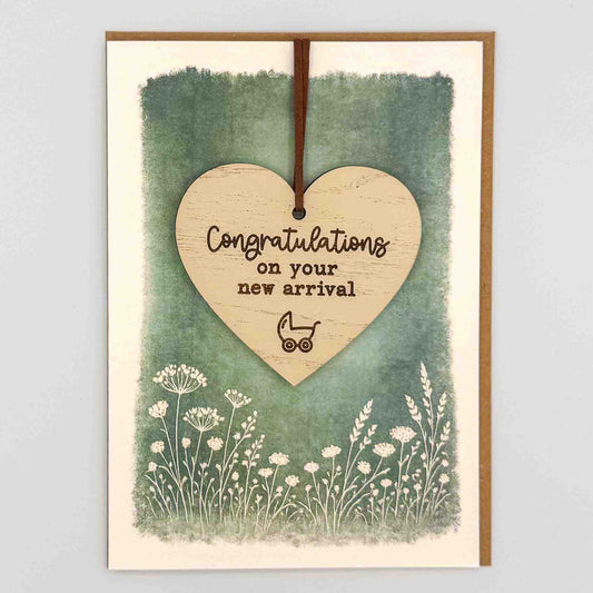 Congratulations new arrival pram heart keepsake card from Sprinkled with Magic, featuring a removable wooden heart keepsake, small pram detail, green botanical design and recycled kraft envelope.