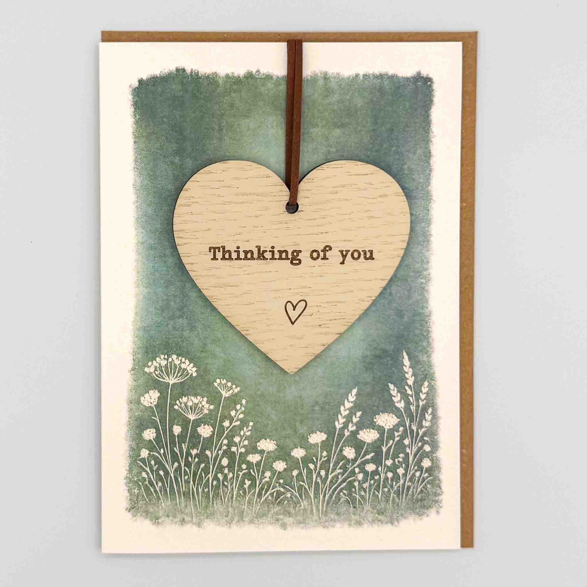 Thinking of you heart keepsake card from Sprinkled with Magic, featuring a removable wooden heart keepsake, green botanical design and recycled kraft envelope.
