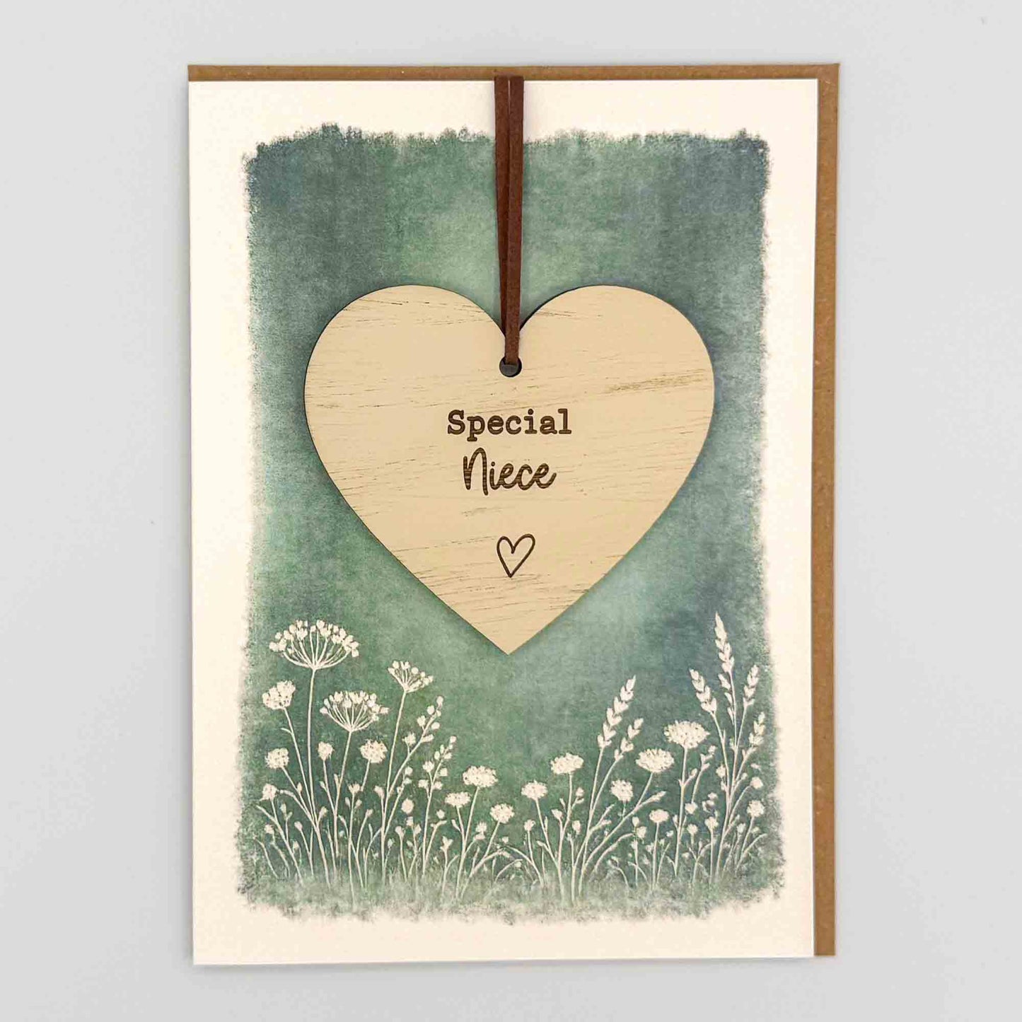 Special niece heart keepsake card from Sprinkled with Magic, featuring a removable wooden heart keepsake, green botanical design and recycled kraft envelope.