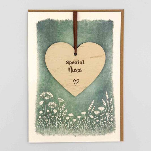 Special niece heart keepsake card from Sprinkled with Magic, featuring a removable wooden heart keepsake, green botanical design and recycled kraft envelope.