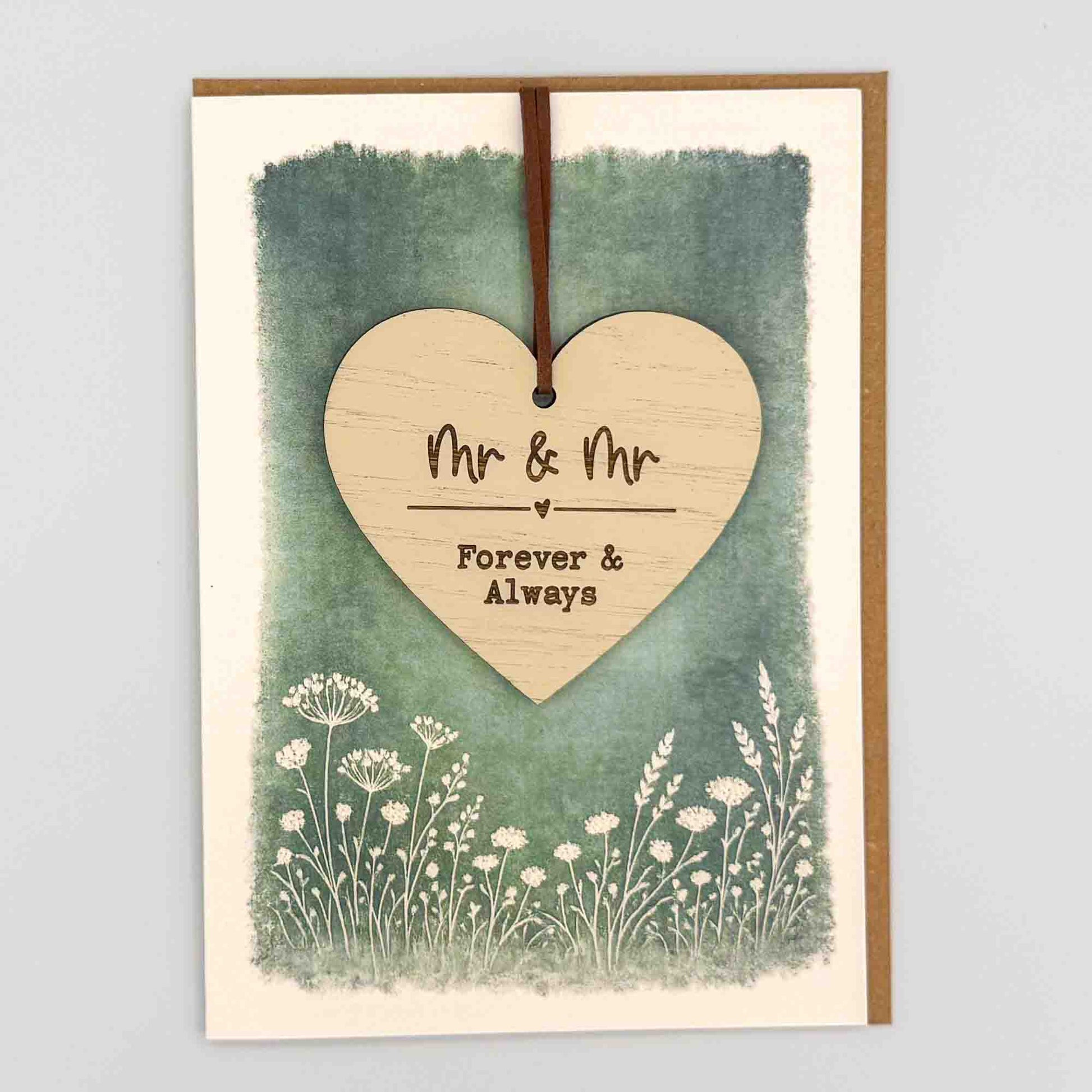 Mr and Mr heart keepsake card from Sprinkled with Magic, featuring a removable wooden wedding heart keepsake, green botanical design and recycled kraft envelope.