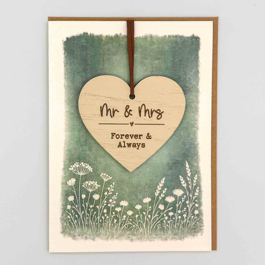 Mr and Mrs heart keepsake card from Sprinkled with Magic, featuring a removable wooden wedding heart keepsake, green botanical design and recycled kraft envelope.