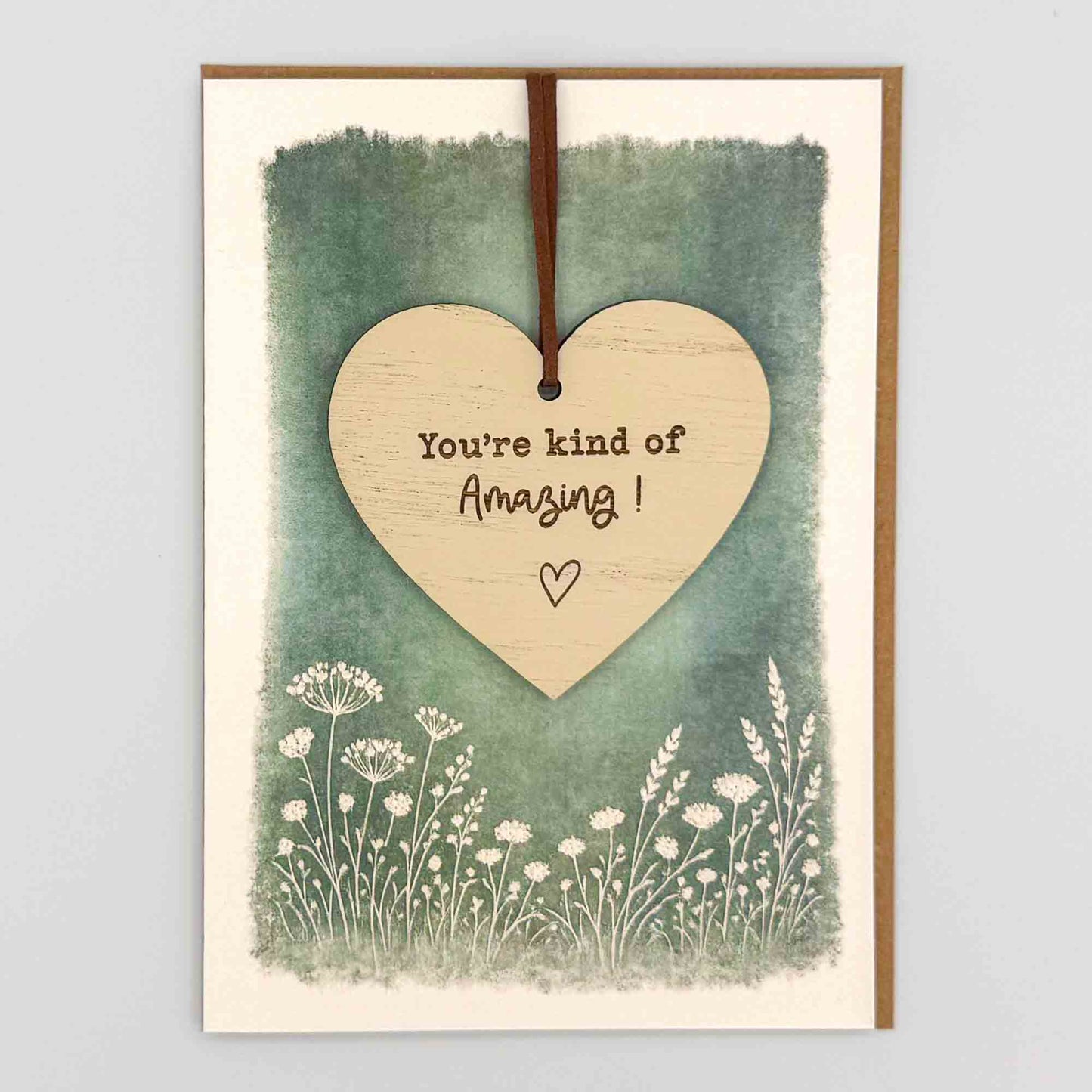 You’re kind of amazing heart keepsake card from Sprinkled with Magic, featuring a removable wooden heart keepsake, green botanical design and recycled kraft envelope.