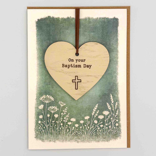 Baptism Day heart keepsake card from Sprinkled with Magic, featuring a removable wooden heart keepsake, cross detail, green botanical design and recycled kraft envelope.