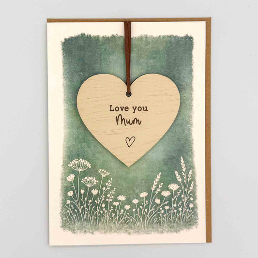 Love you Mum heart keepsake card from Sprinkled with Magic, featuring a removable wooden heart keepsake, green botanical design and recycled kraft envelope.