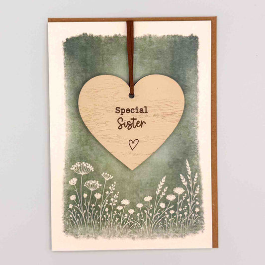 Special sister heart keepsake card from Sprinkled with Magic, featuring a removable wooden heart keepsake, green botanical design and recycled kraft envelope.