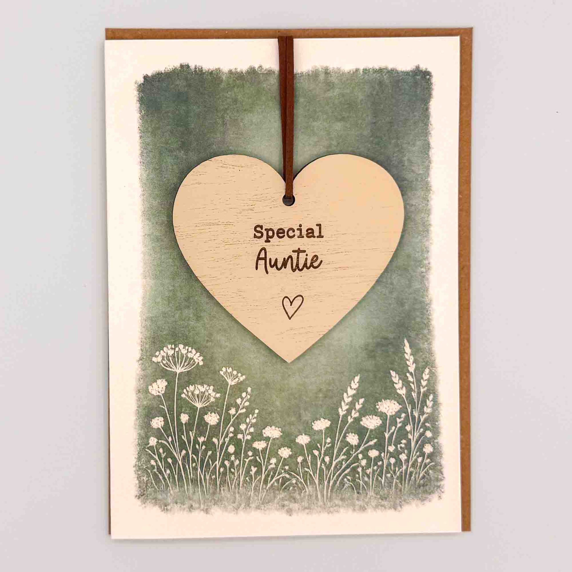 Special auntie heart keepsake card from Sprinkled with Magic, featuring a removable wooden heart keepsake, green botanical design and recycled kraft envelope.