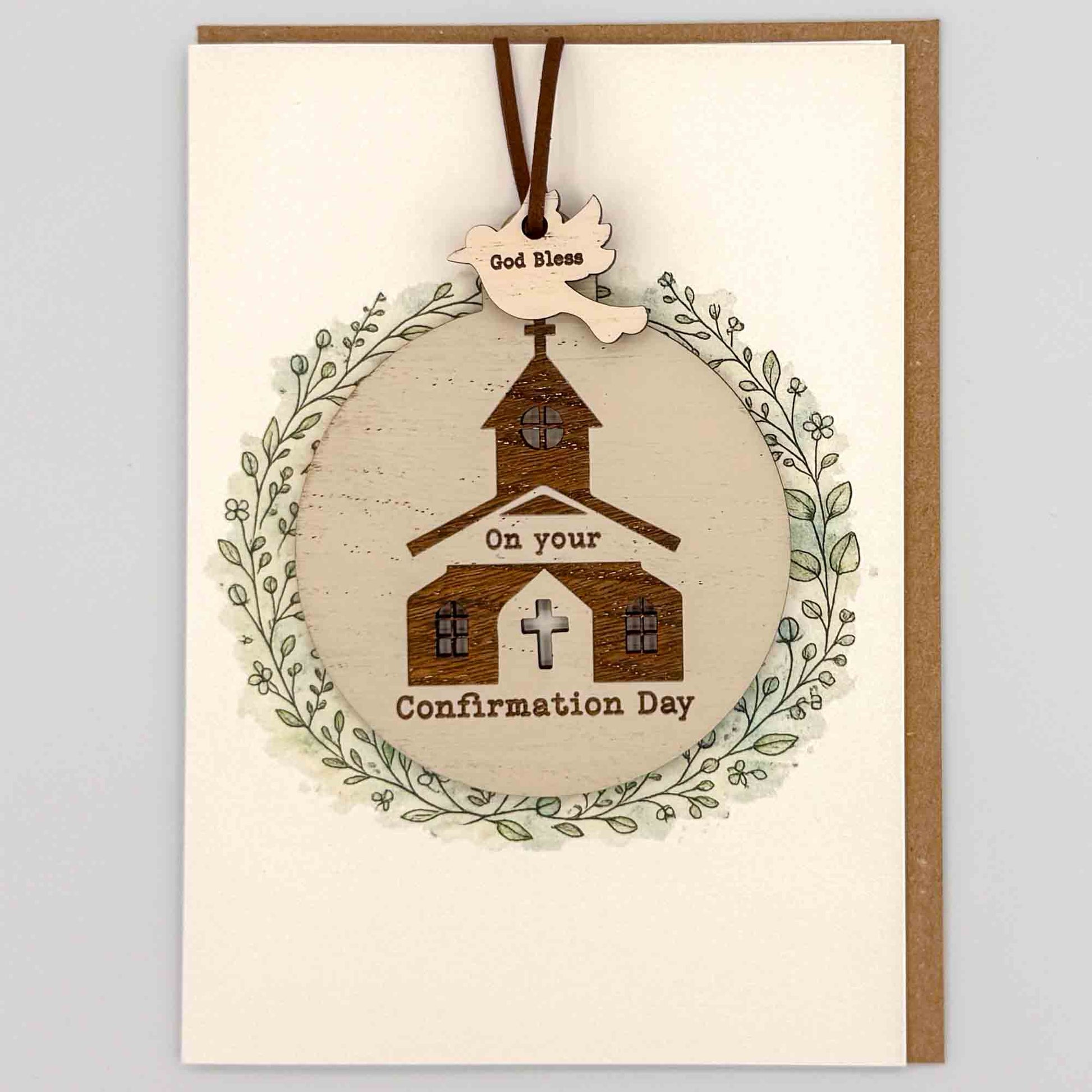 Confirmation Day church bauble keepsake card from Sprinkled with Magic, featuring a removable wooden church bauble keepsake, cross detail, leafy wreath design and recycled kraft envelope.