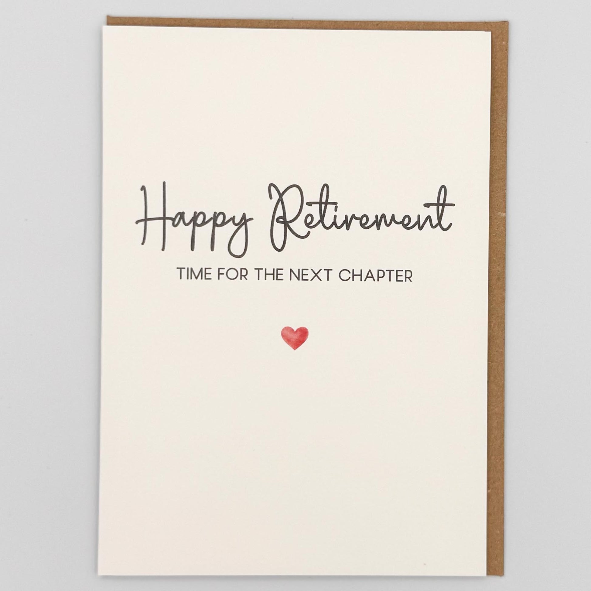 Happy retirement next chapter card from Sprinkled with Magic, featuring handwritten-style retirement wording, a small red heart and recycled kraft envelope.