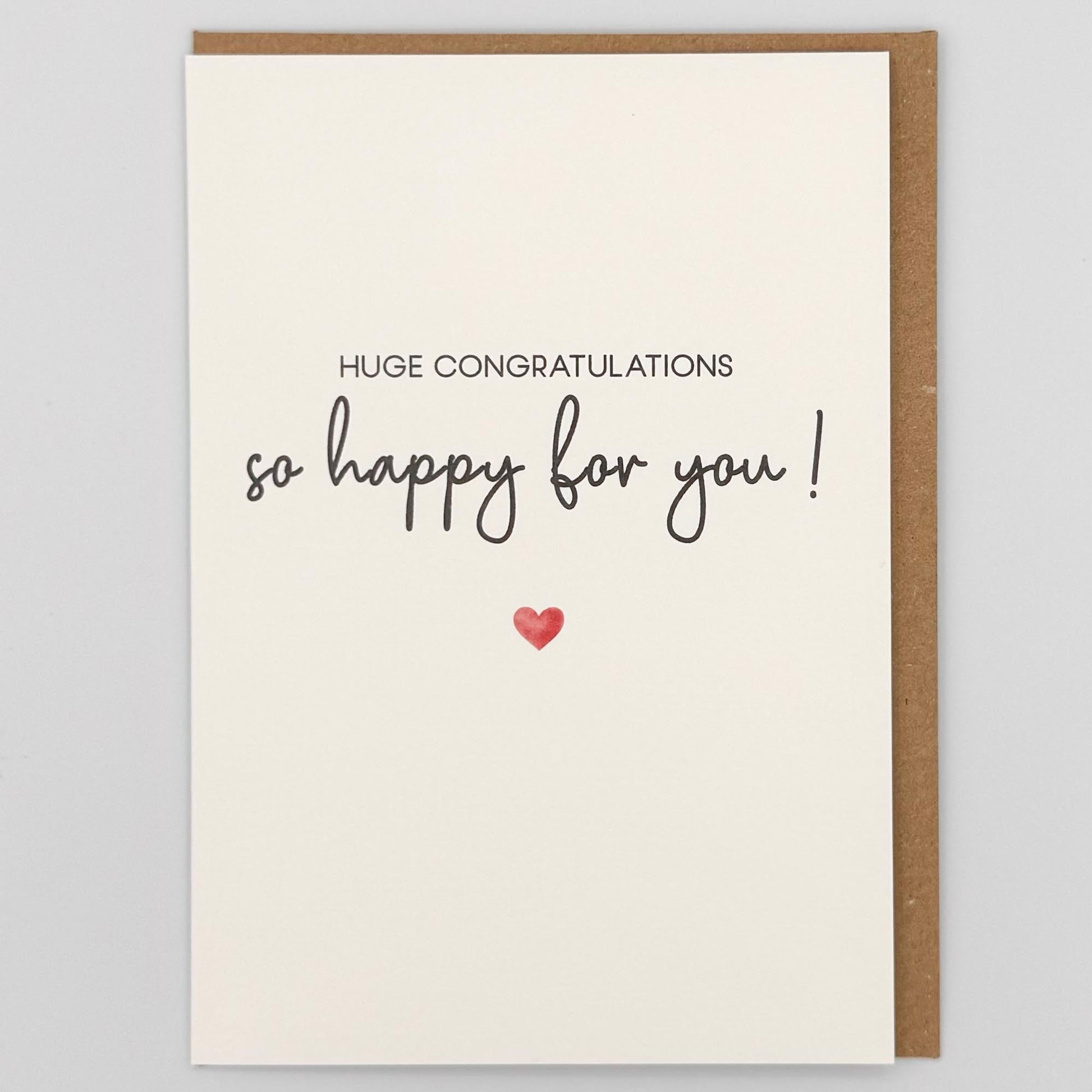 Huge congratulations so happy for you greeting card from Sprinkled with Magic, featuring handwritten-style wording, a small red heart and recycled kraft envelope.