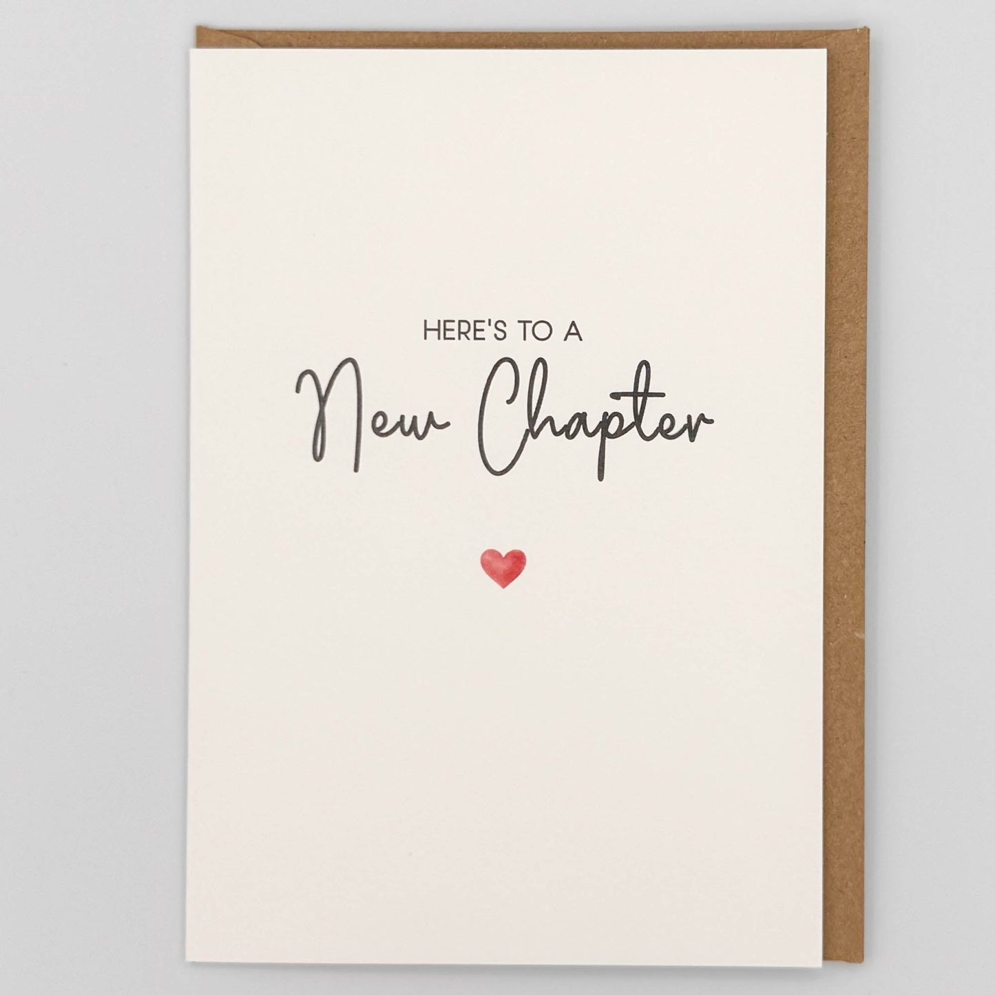 New chapter greeting card from Sprinkled with Magic, featuring handwritten-style wording, a small red heart and recycled kraft envelope.