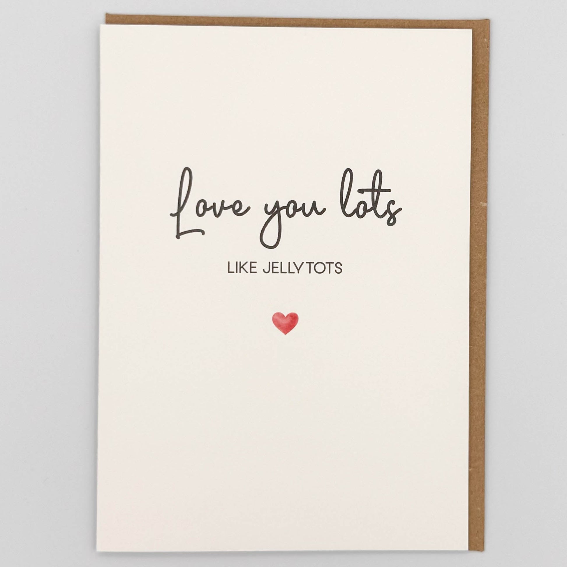 Love you lots card from Sprinkled with Magic, featuring handwritten-style jellytots wording, a small red heart and recycled kraft envelope.