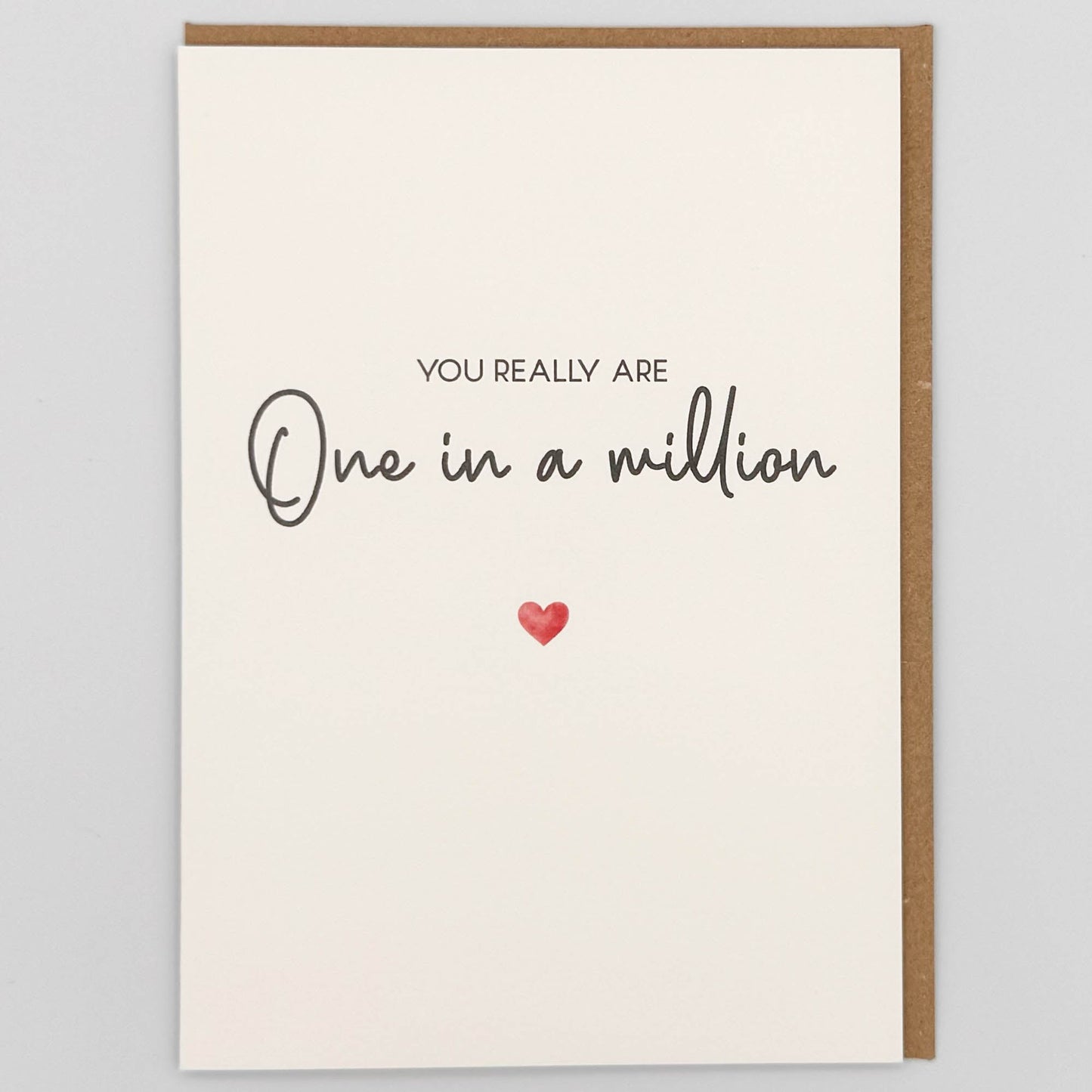 One in a million greeting card from Sprinkled with Magic, featuring simple handwritten-style wording, a small red heart and recycled kraft envelope.