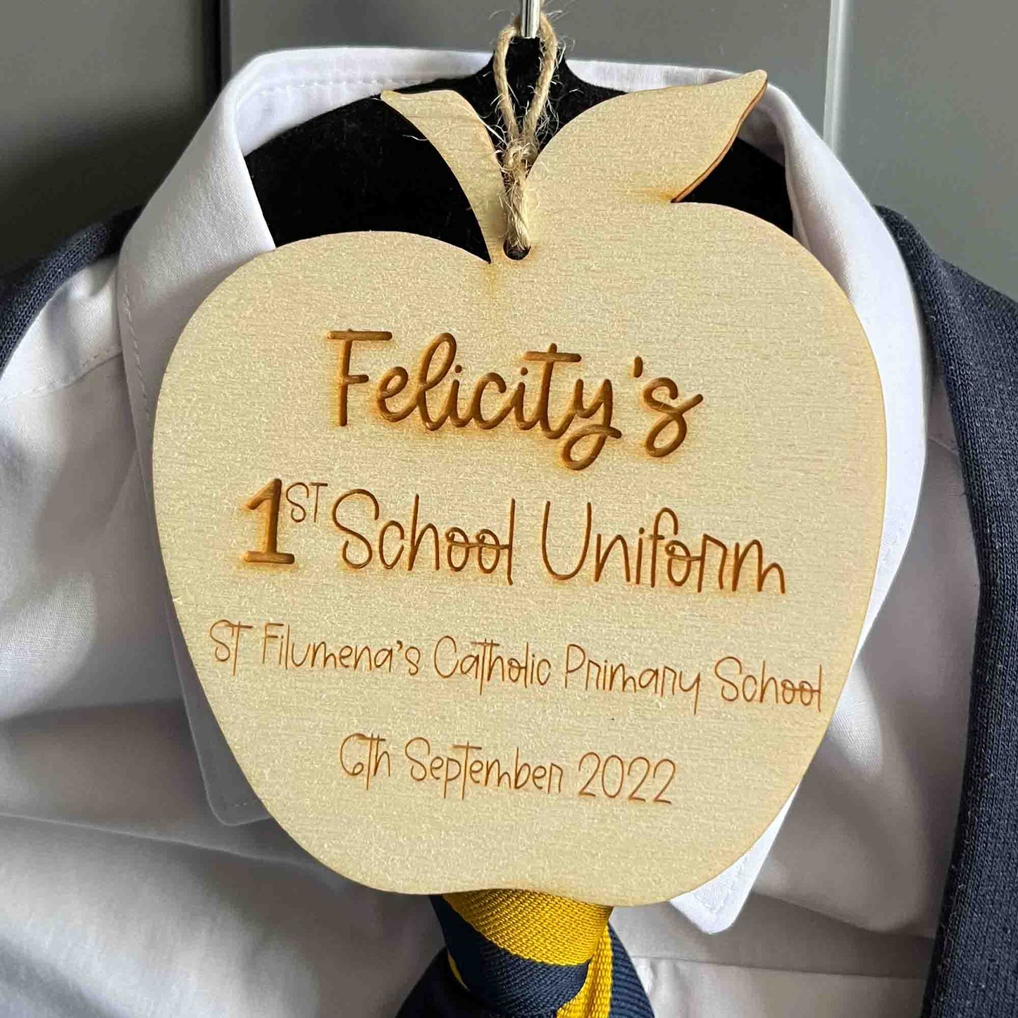 1st school uniform hanger tag. in shape of an apple