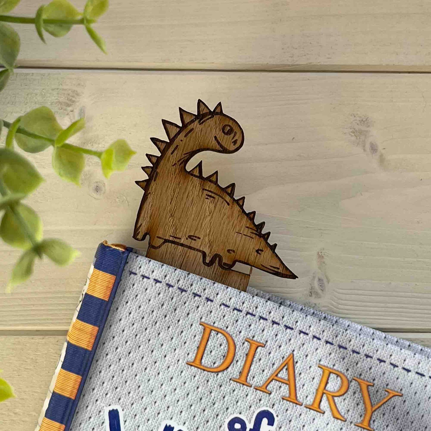 dinosaur bookmark in a book